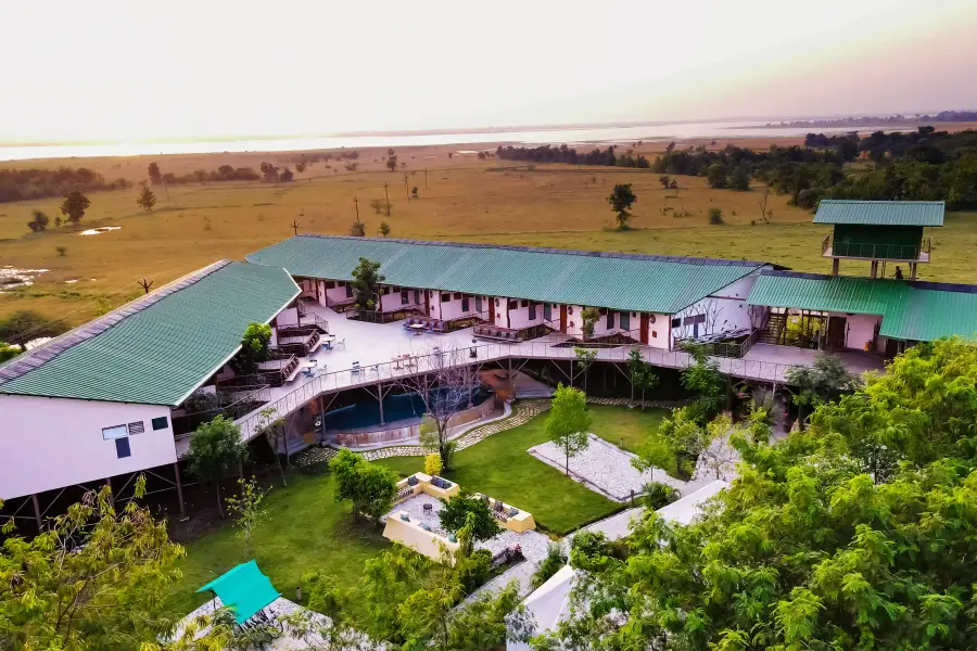 a luxury stay from the air, tucked against the tree line near Tadoba