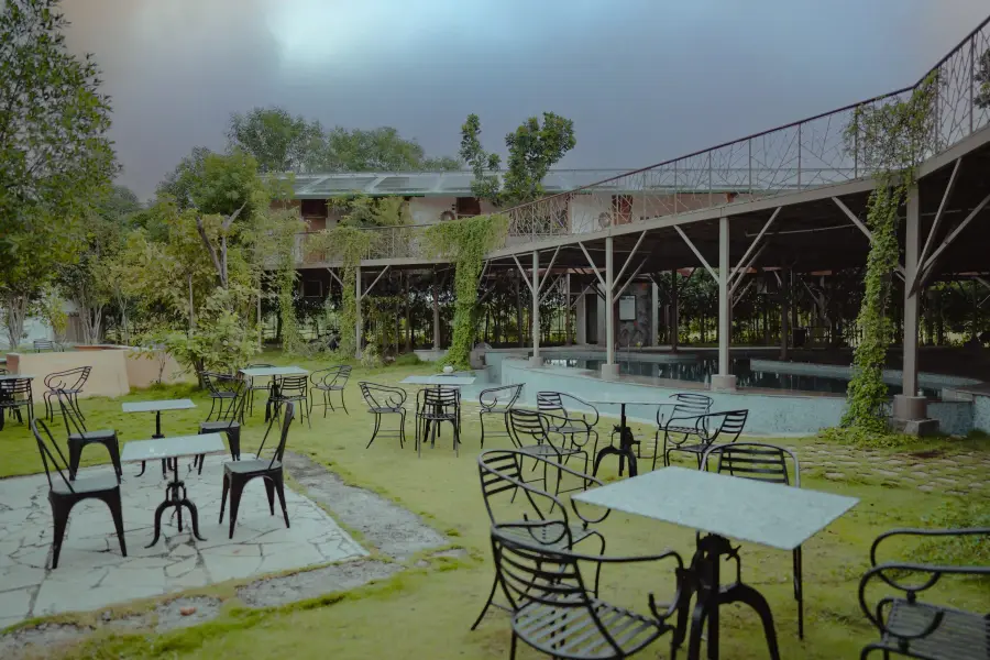 The green-roofed main lodge building at a luxury stay, Tadoba