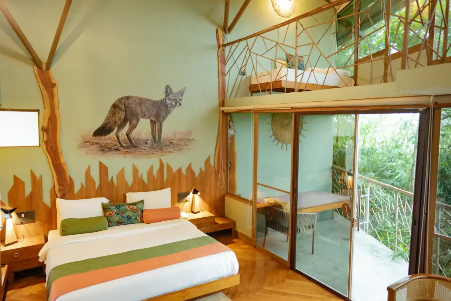 King bed and hand-carved timber headboard in a room at a luxury stay