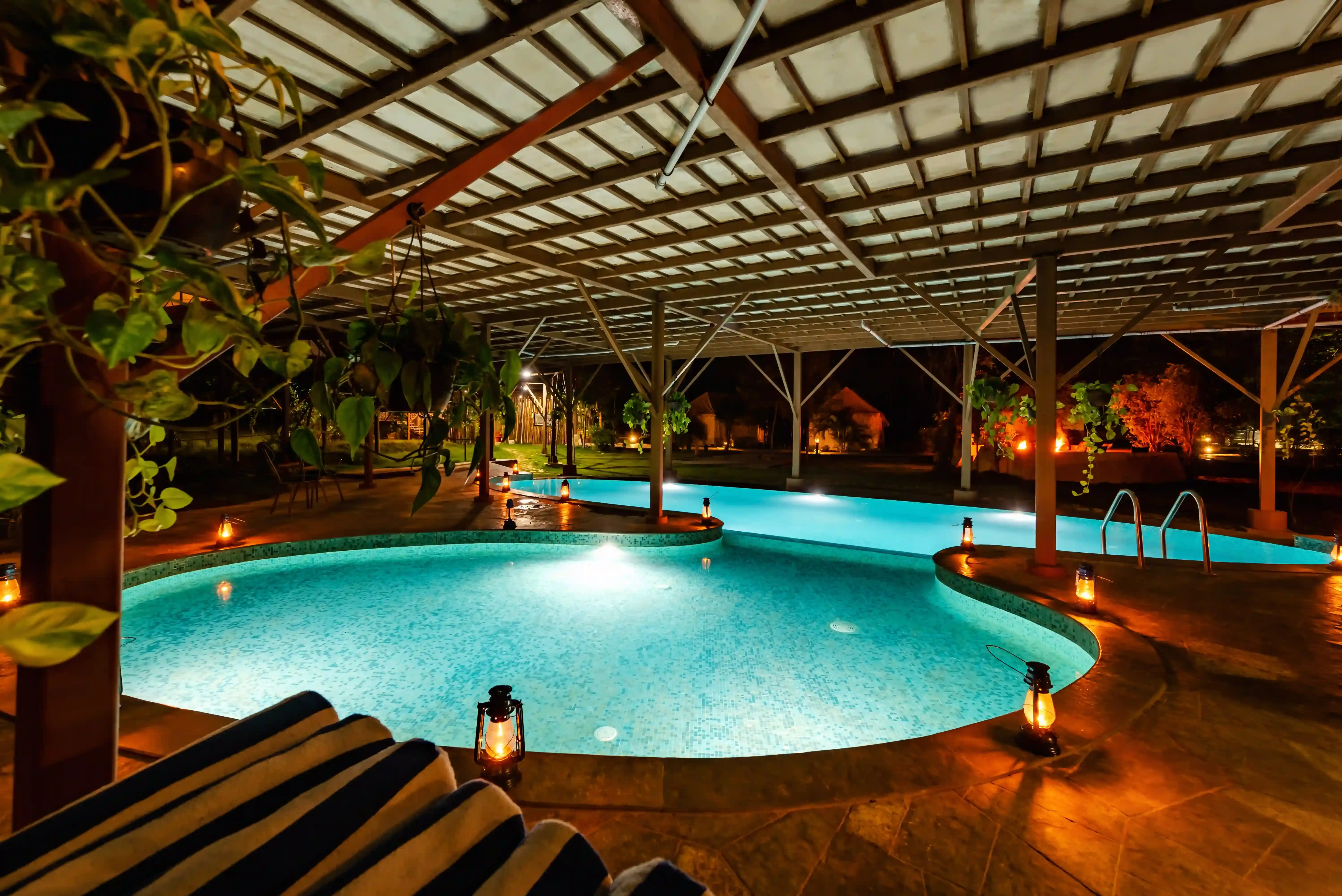 Pool under a timber canopy at a resort near Tadoba