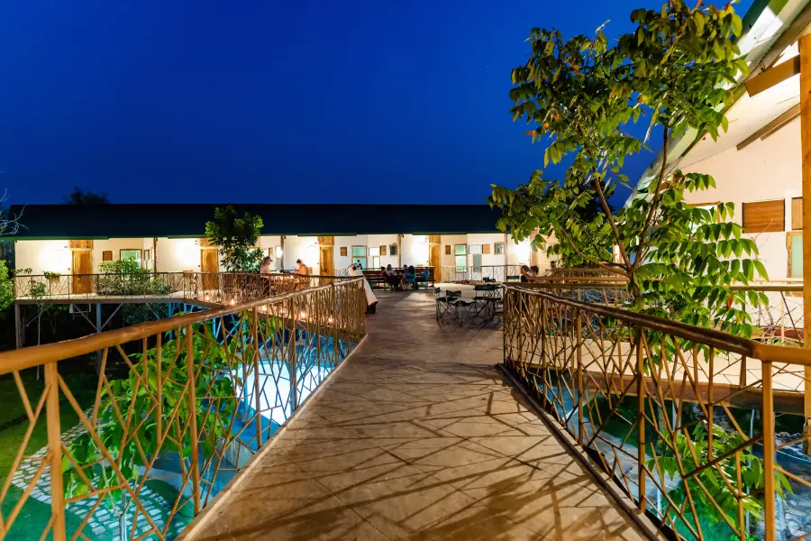 Blue-hour deck and pool at a luxury stay, set for dinner under the stars