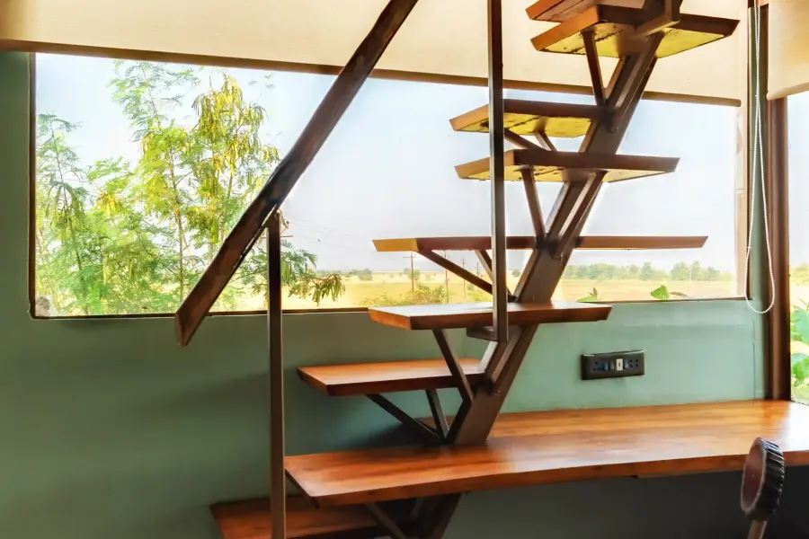 Loft suite with double-height forest windows at a luxury stay