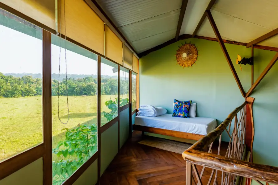 Balcony day-bed overlooking the grassland at a luxury stay