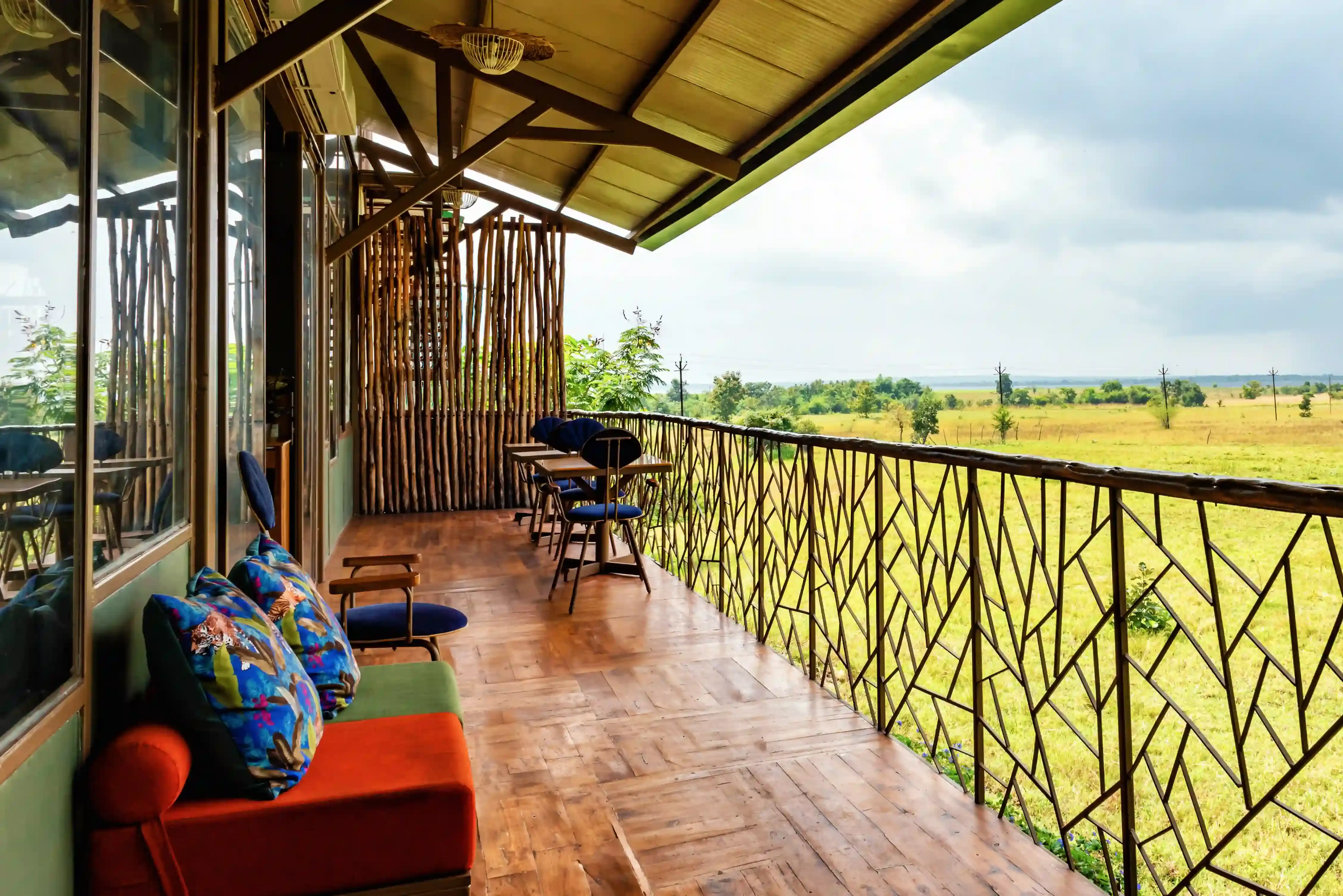 Veranda lounge overlooking grassland at a resort near Tadoba