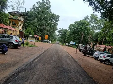 Road and parked safari vehicles at Agarzari gate, Tadoba buffer