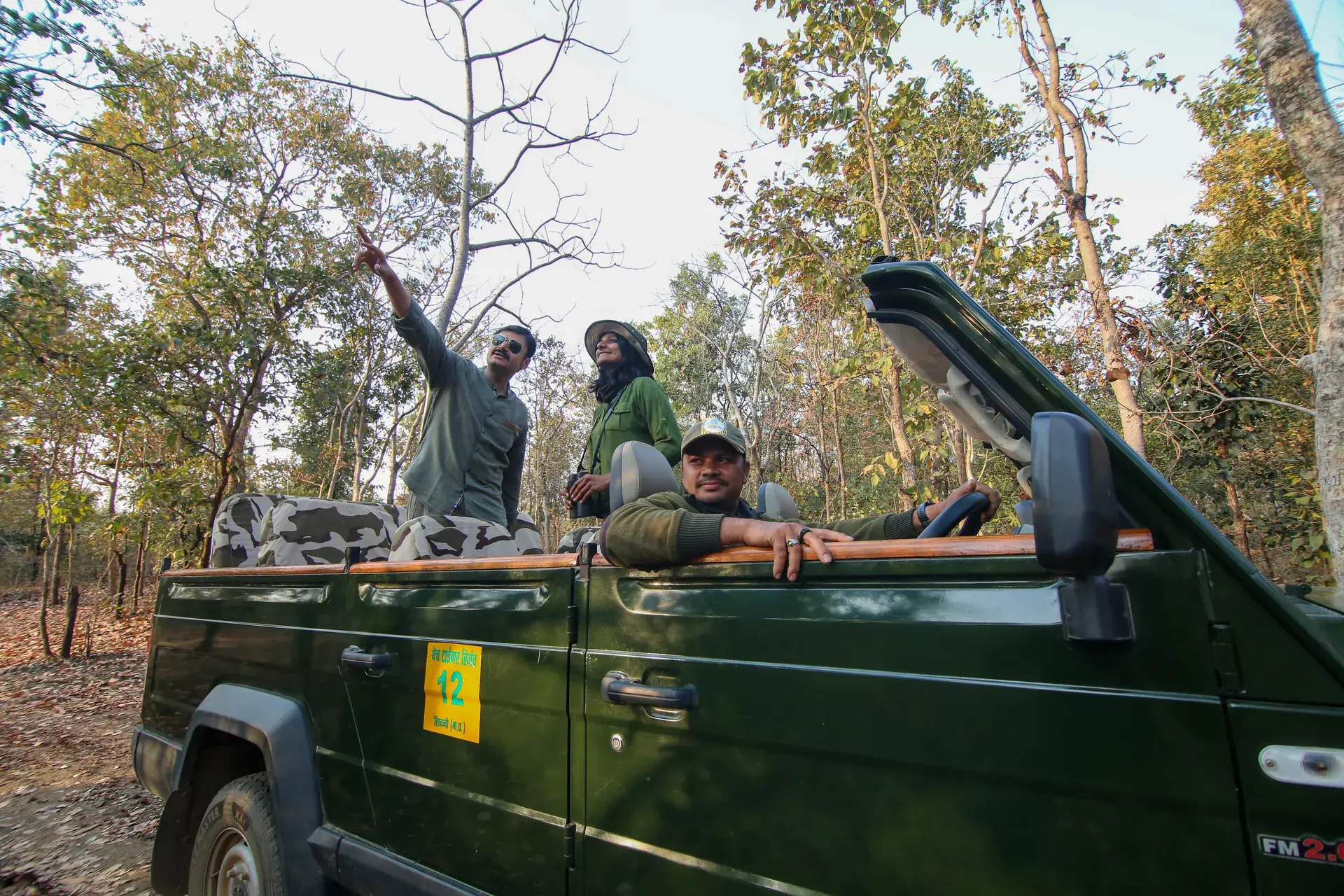 Guests scanning the forest with a naturalist in Pench