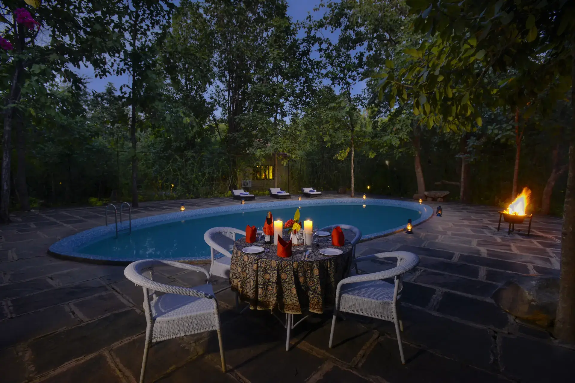 Dinner by a lit pool