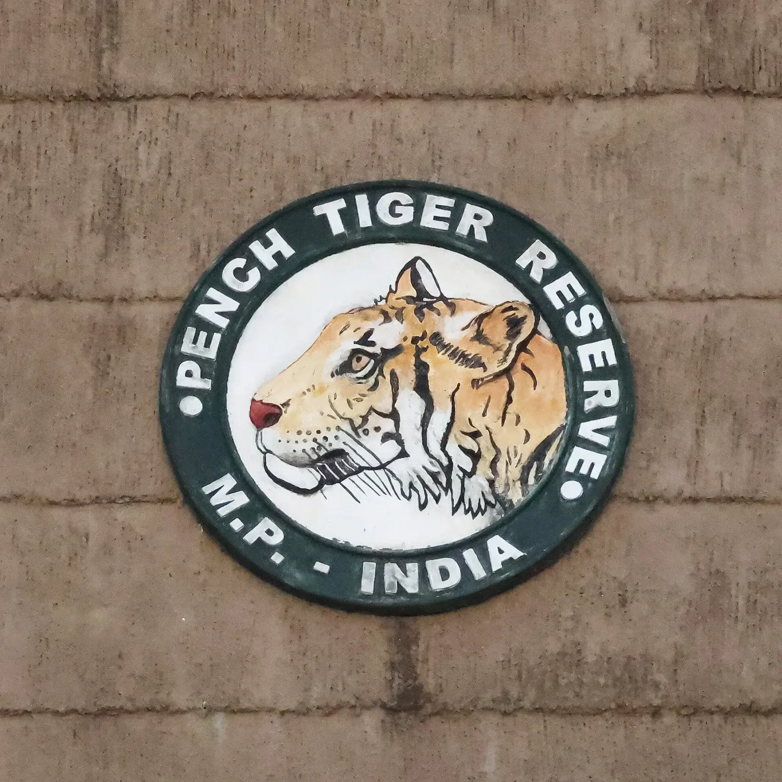 Pench Tiger Reserve emblem on a stone wall, Madhya Pradesh