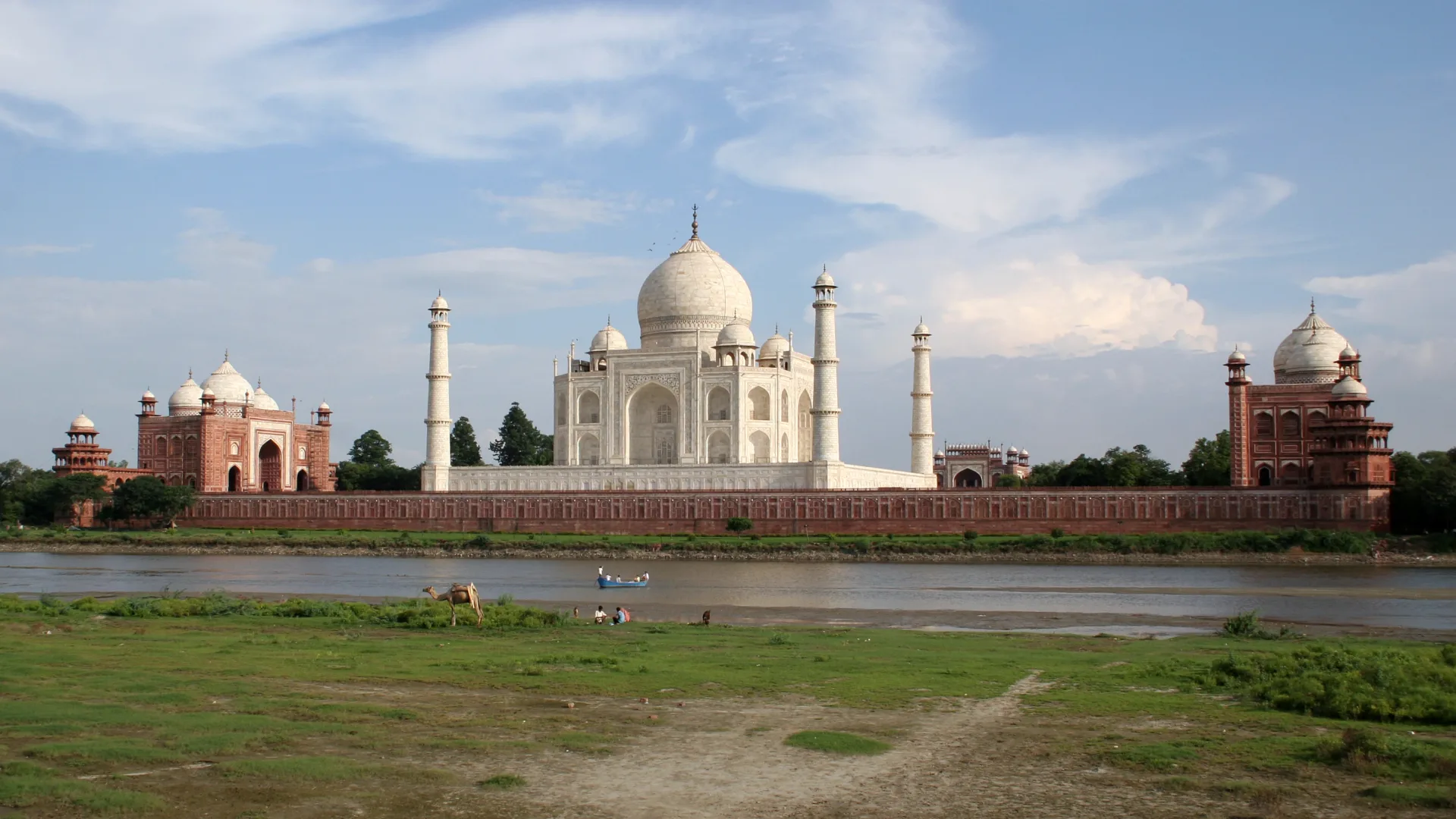 The Taj Mahal in Agra seen across the Yamuna River at sunset
